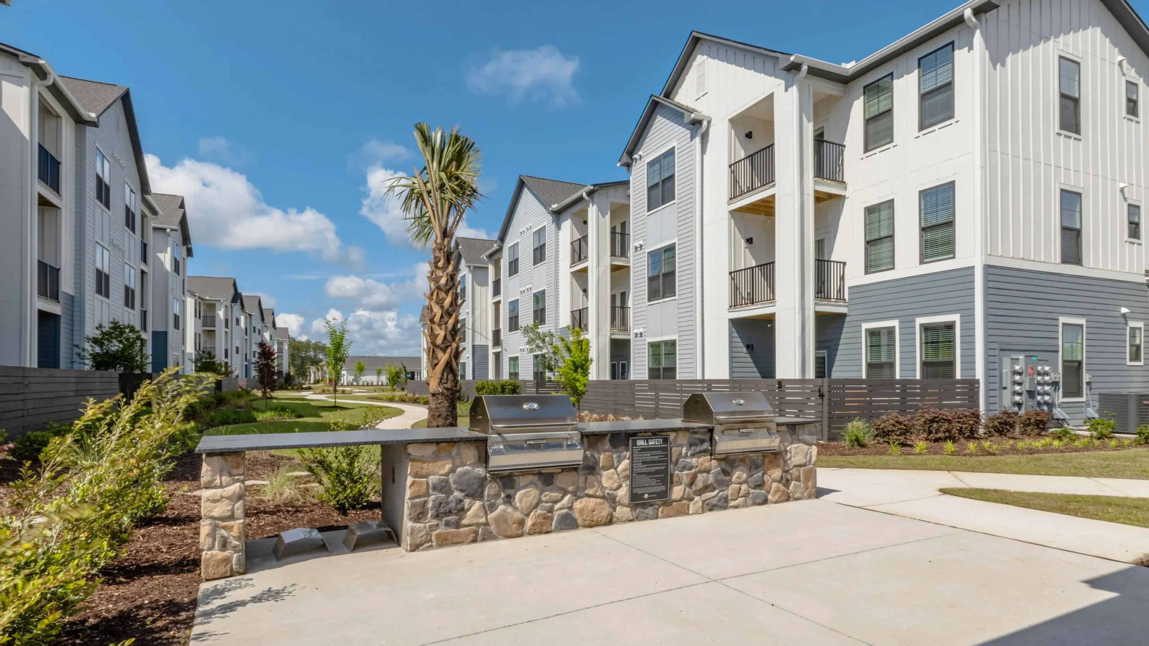 Holly Ridgeluxury outdoor pool with in-pool lounge chairs and surrounding seating