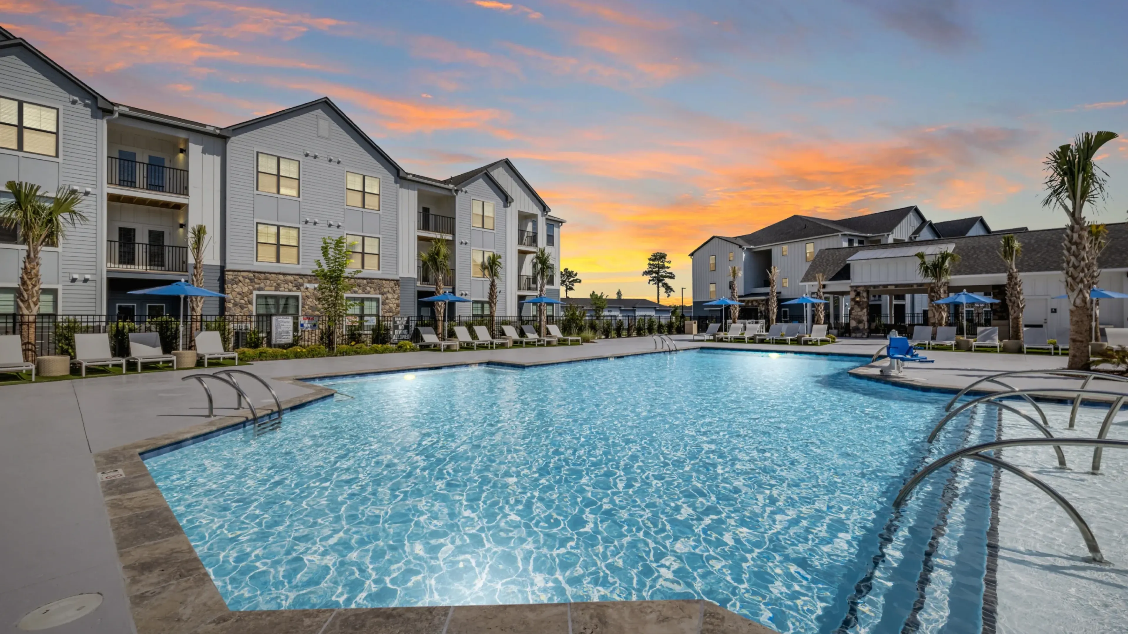 Holly Ridgeluxury outdoor pool with in-pool lounge chairs and surrounding seating