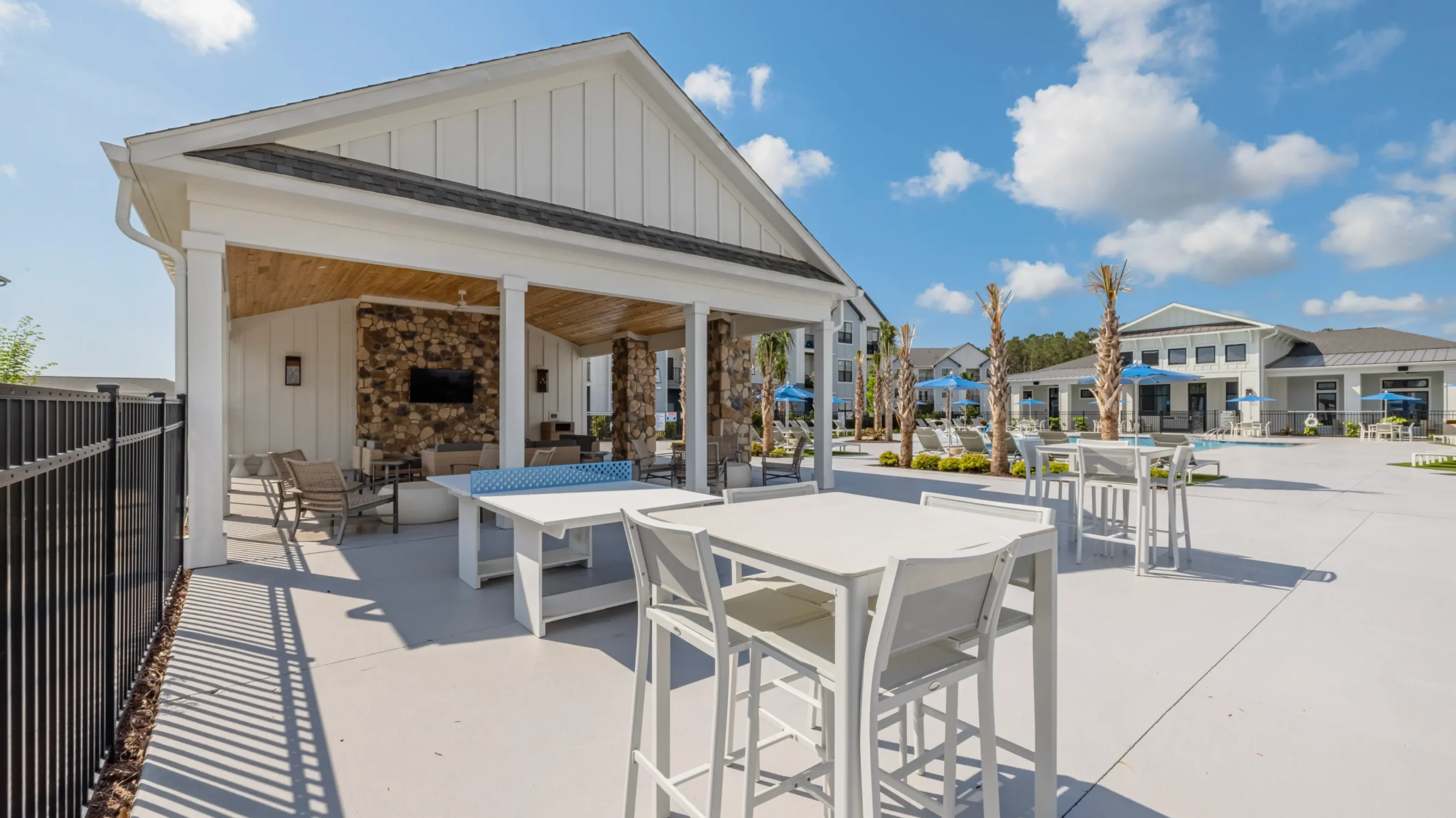 Holly Ridgepartments community exterior with large green lawn and outdoor pool area